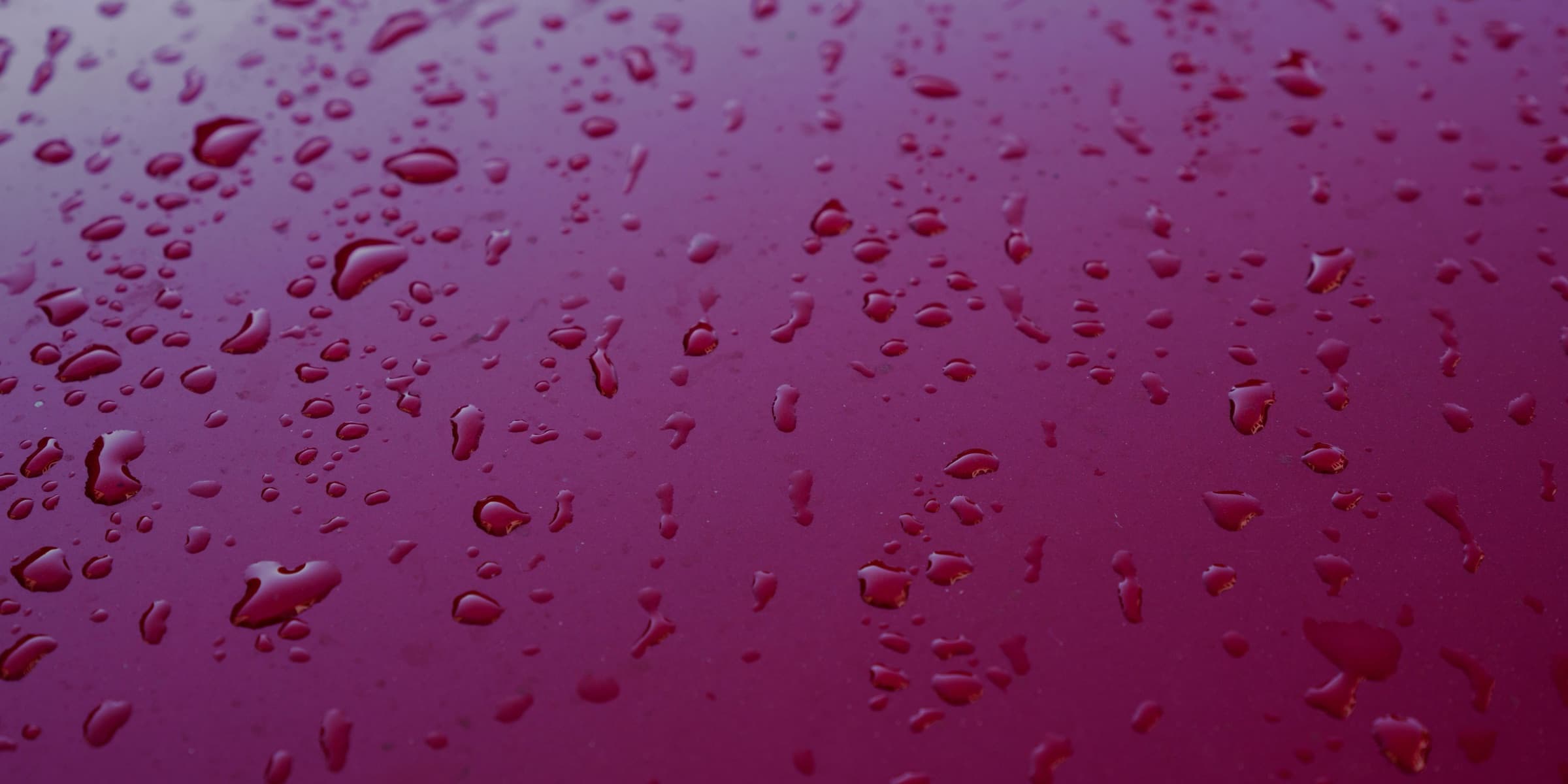 Water drops beading on a metal surface